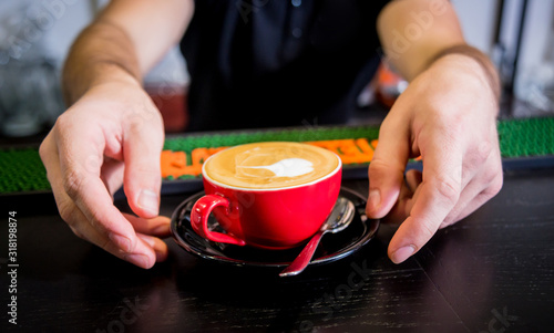 Barista making cappuccino coffee pouring milk. Background. Chocolate