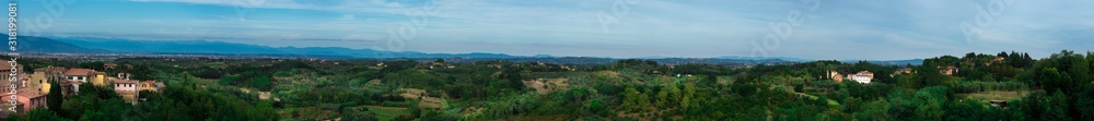 Wide panorama shot of a beautiful Italian landscape with mountains and cities