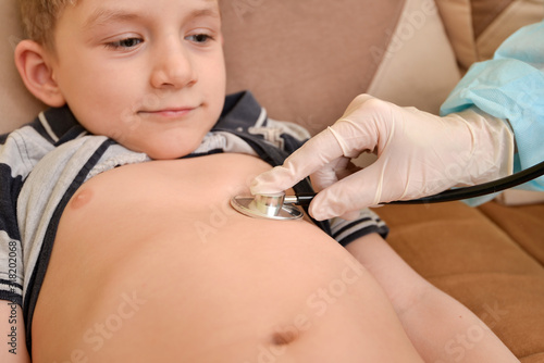 The doctor measures the temperature of the child with the disease.