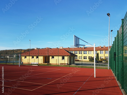 Lubno, Poland - july 9 2018:An open stadium in the courtyard of a village school. Eduction of the younger generation. Sports ground for football, volleyball and basketball. Lighting on natural sources