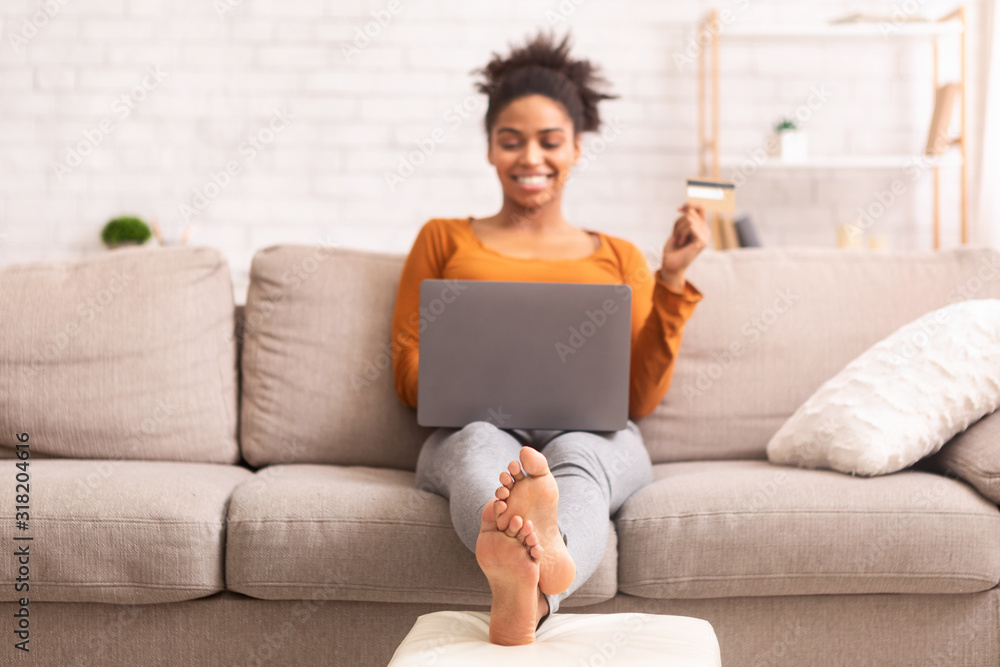 African American Girl Doing Online Shopping Sitting On Sofa Indoor African American Girl Doing Online Shopping Sitting On Sofa Indoor