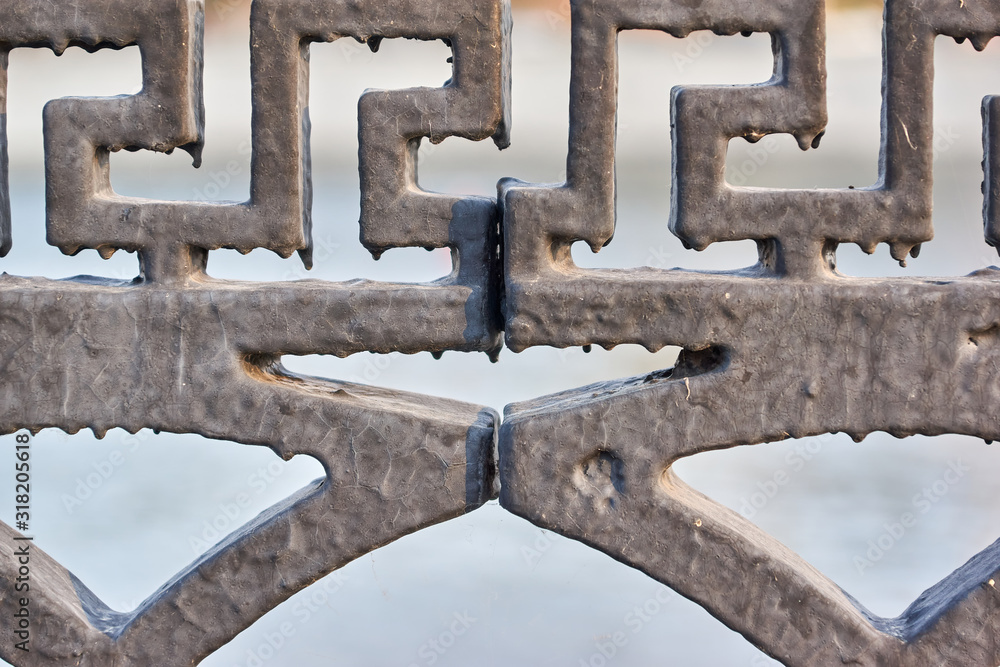 Fragment of a metal fence with leaked paint