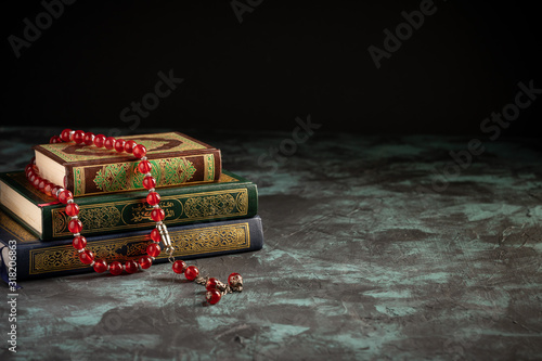 Photography Islamic concept: The holy Quran and Tasbih (rosary beads) on dark background