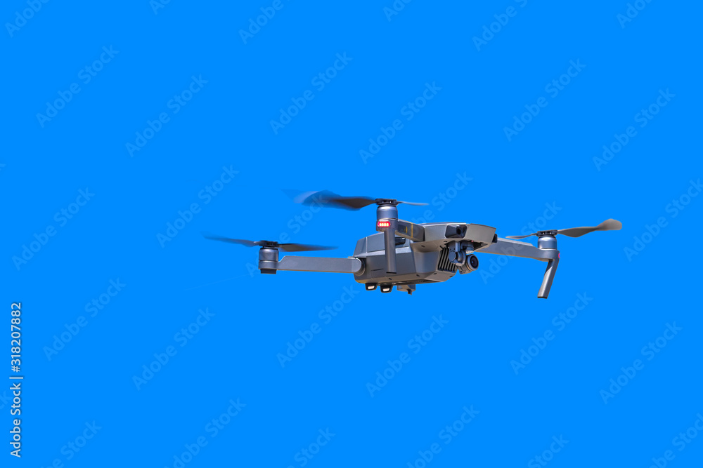 Fototapeta premium Modern drone with camera flying on a clear blue sky