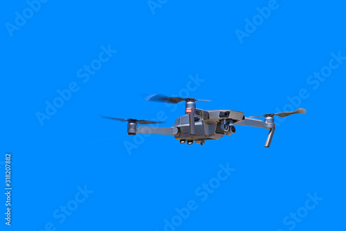 Fototapeta Naklejka Na Ścianę i Meble -  Modern drone with camera flying on a clear blue sky