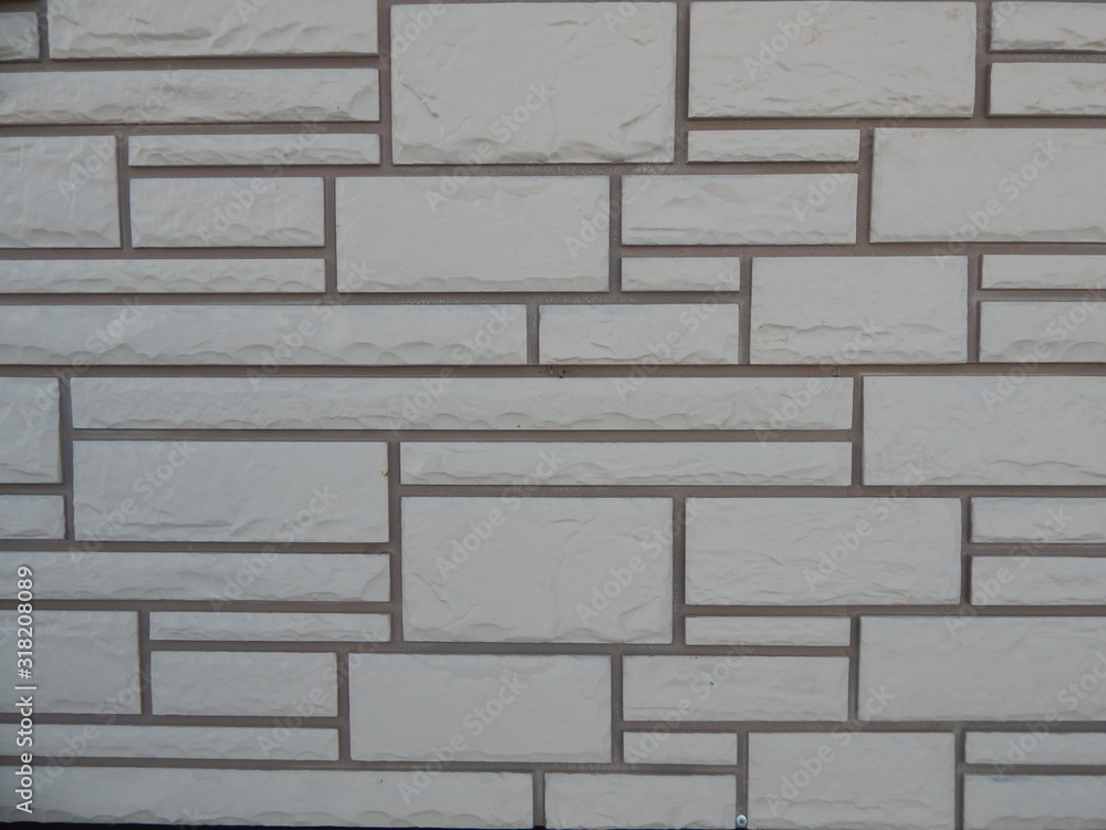 fragment of the exterior wall of the building with textured geometric cladding and dark seams fragment of the exterior wall of the building with textured geometric cladding and dark seams