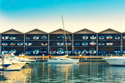 Multi-storey storage of boats and berths on its background