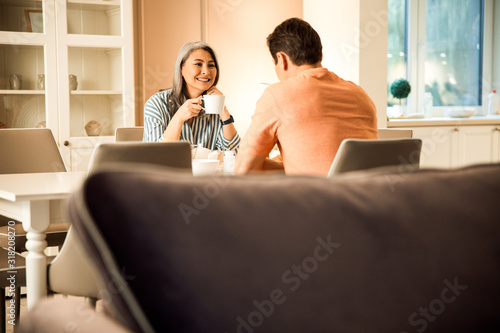 Happy attractive woman looking at man while talking