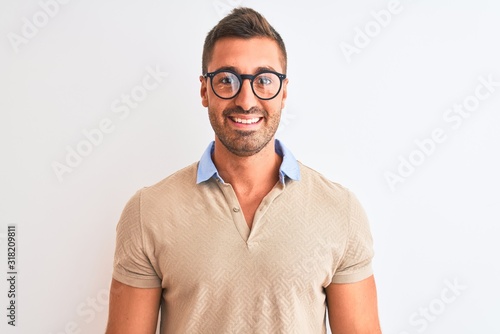 Young handsome man wearing glasses over isolated background with a happy and cool smile on face. Lucky person. © Krakenimages.com