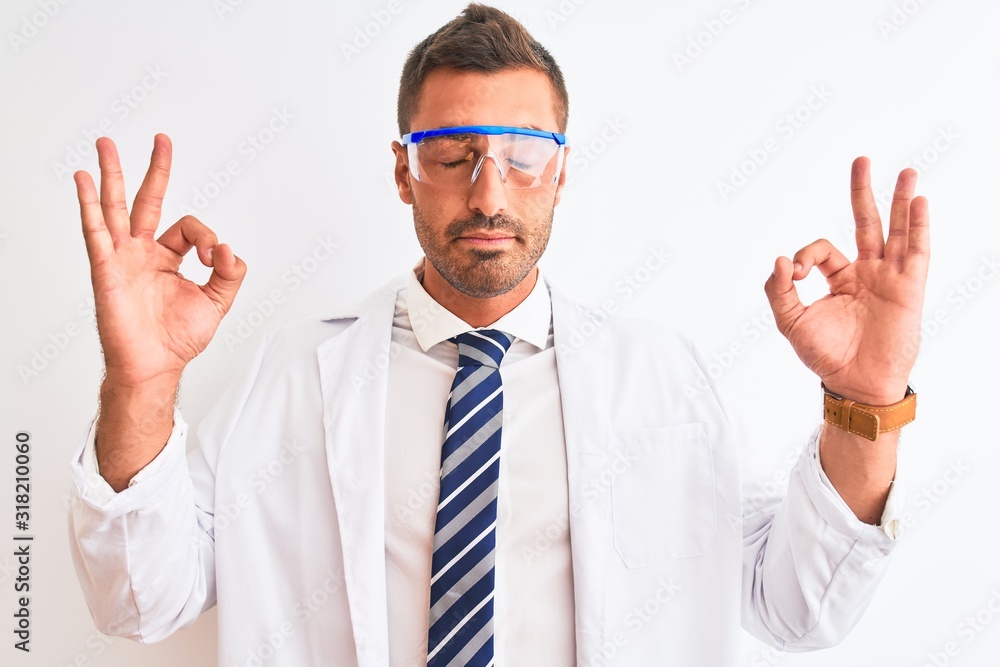Young handsome scientist man wearing safety glasses over isolated background relax and smiling with eyes closed doing meditation gesture with fingers. Yoga concept. Young handsome scientist man wearing safety glasses over isolated background relax and smiling with eyes closed doing meditation gesture with fingers. Yoga concept.