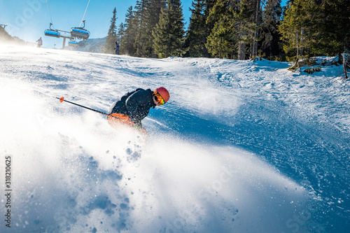 Snow cloud produced by aggressive braking from a young skier