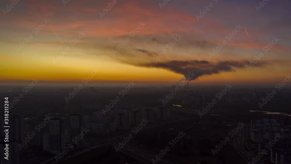 Aerial view hyperlapse of sunset in Minsk city. A residential area of the city and a smoky power plant at dusk. Aerial view hyperlapse of sunset in Minsk city. A residential area of the city and a smoky power plant at dusk.