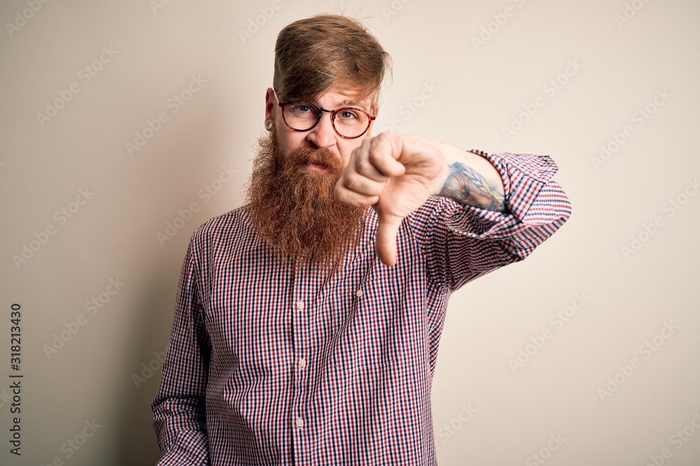 Handsome Irish redhead business man with beard wearing glasses over isolated background looking unhappy and angry showing rejection and negative with thumbs down gesture. Bad expression. Handsome Irish redhead business man with beard wearing glasses over isolated background looking unhappy and angry showing rejection and negative with thumbs down gesture. Bad expression.
