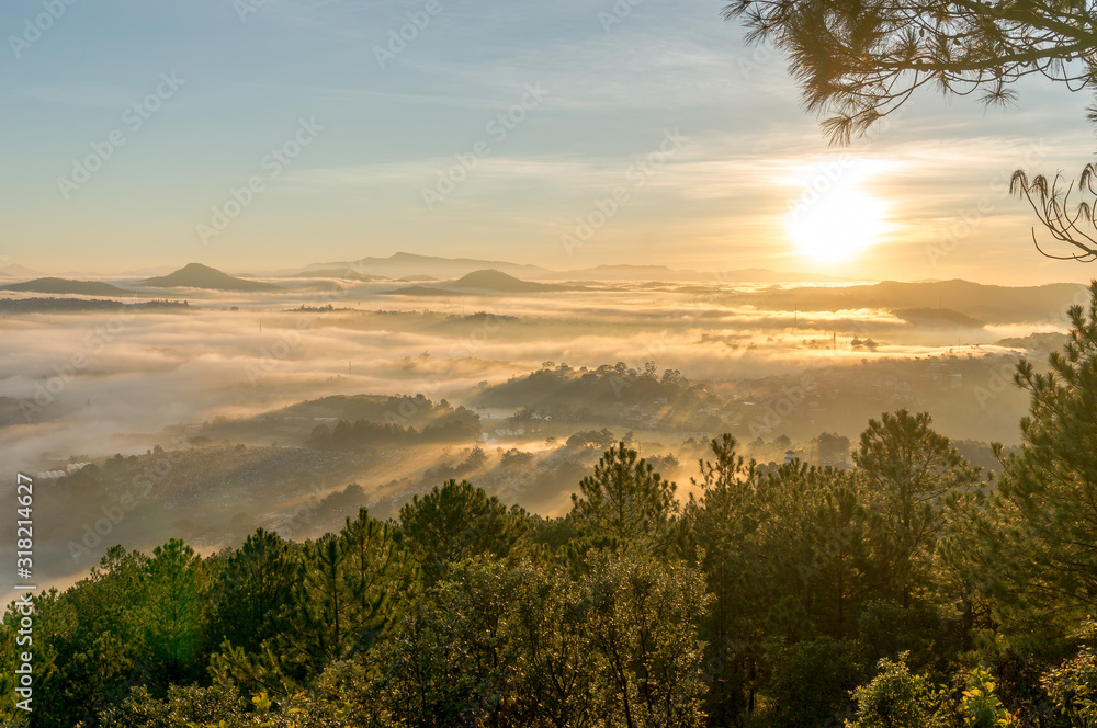 nice day in Da Lat, on the top of mountain view down of city in fog, sun light and rays