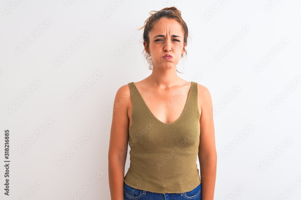 Young redhead woman wearing a bun over isolated background puffing cheeks with funny face. Mouth inflated with air, crazy expression. Young redhead woman wearing a bun over isolated background puffing cheeks with funny face. Mouth inflated with air, crazy expression.