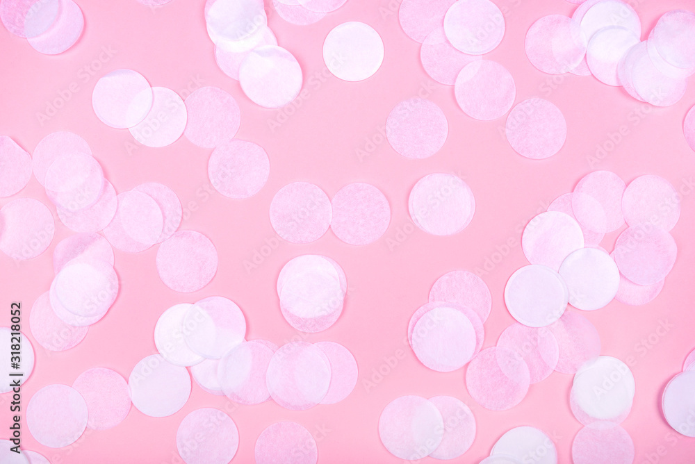 White confetti on pink background. Flat lay, top view.