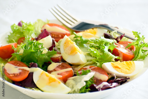 Egg salad with tomato, lettuce and red cabbage. Selective focus. 
