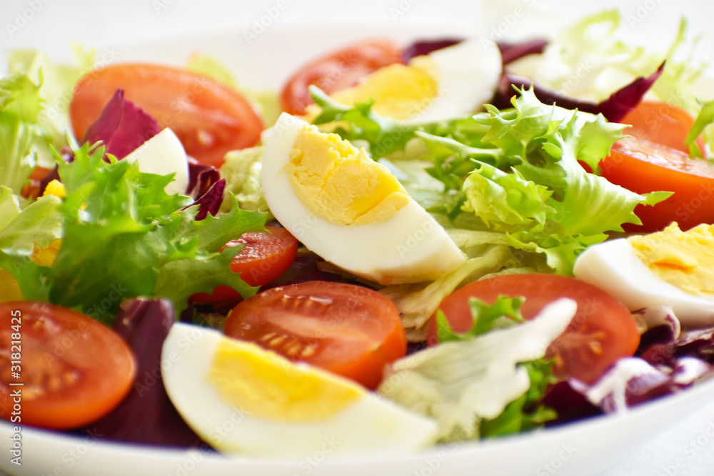 Egg salad with tomato, lettuce and red cabbage. Selective focus. Egg salad with tomato, lettuce and red cabbage. Selective focus.