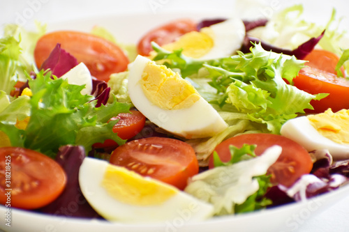 Egg salad with tomato, lettuce and red cabbage. Selective focus. 