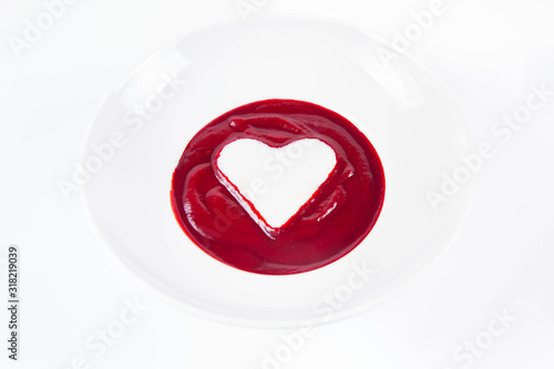 Beetroot cream soup decorated with a heart made of yoghurt