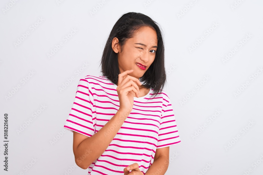 Young chinese woman wearing striped t-shirt standing over isolated white background disgusted expression, displeased and fearful doing disgust face because aversion reaction. With hands raised Young chinese woman wearing striped t-shirt standing over isolated white background disgusted expression, displeased and fearful doing disgust face because aversion reaction. With hands raised