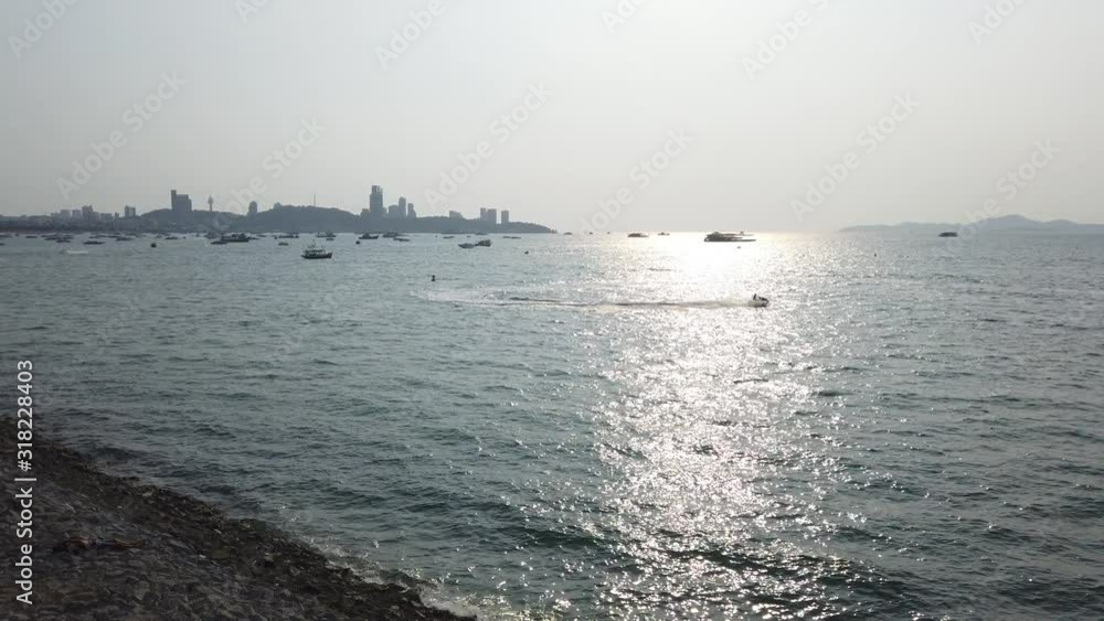 Pattaya, Thailand, view to sea where is boats and water scooters. Pattaya, Thailand, view to sea where is boats and water scooters.