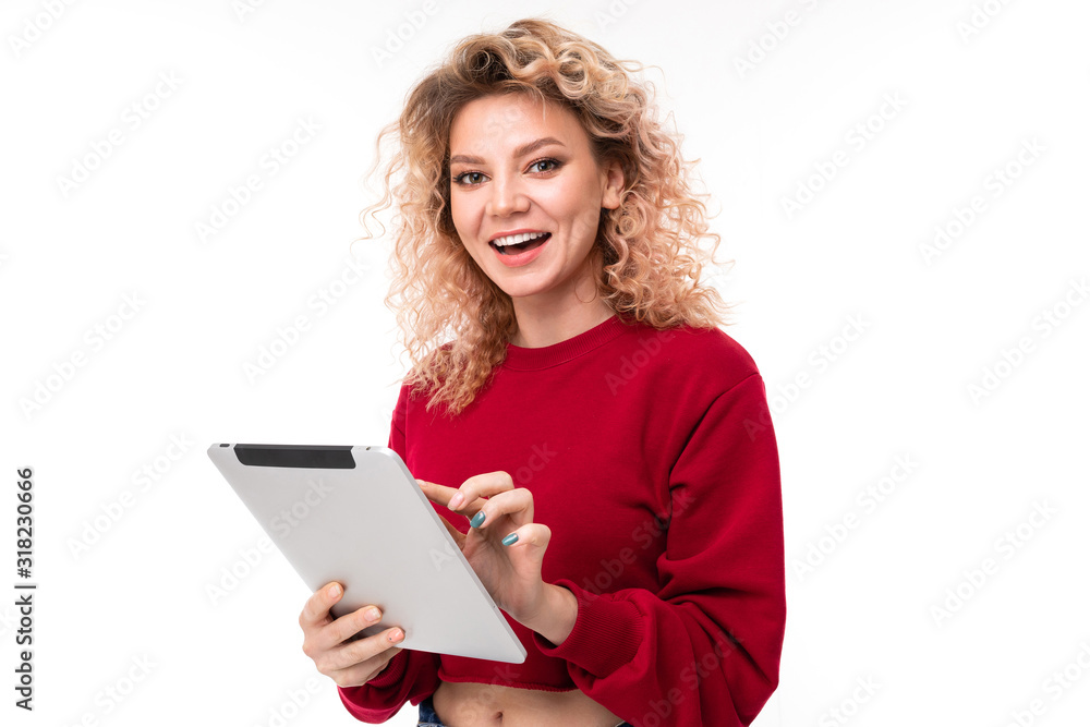 Emotional caucasian girl with curly fair hair chatting with friends and laughing Emotional caucasian girl with curly fair hair chatting with friends and laughing