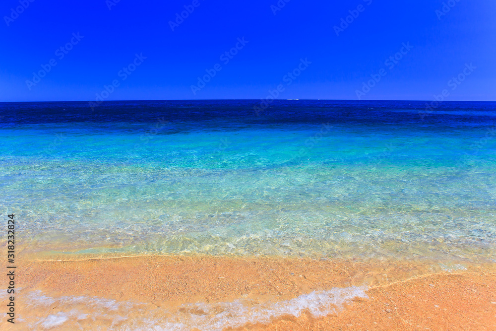 Beautiful sea summer or spring abstract background. Golden sand beach with blue ocean