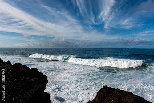 Dangerious ocean stormy waves hits black lava rocks by Faro de las Hoyas, La Palma island, Canary, Spain