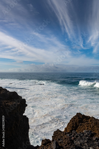 Dangerious ocean stormy waves hits black lava rocks by Faro de las Hoyas, La Palma island, Canary, Spain