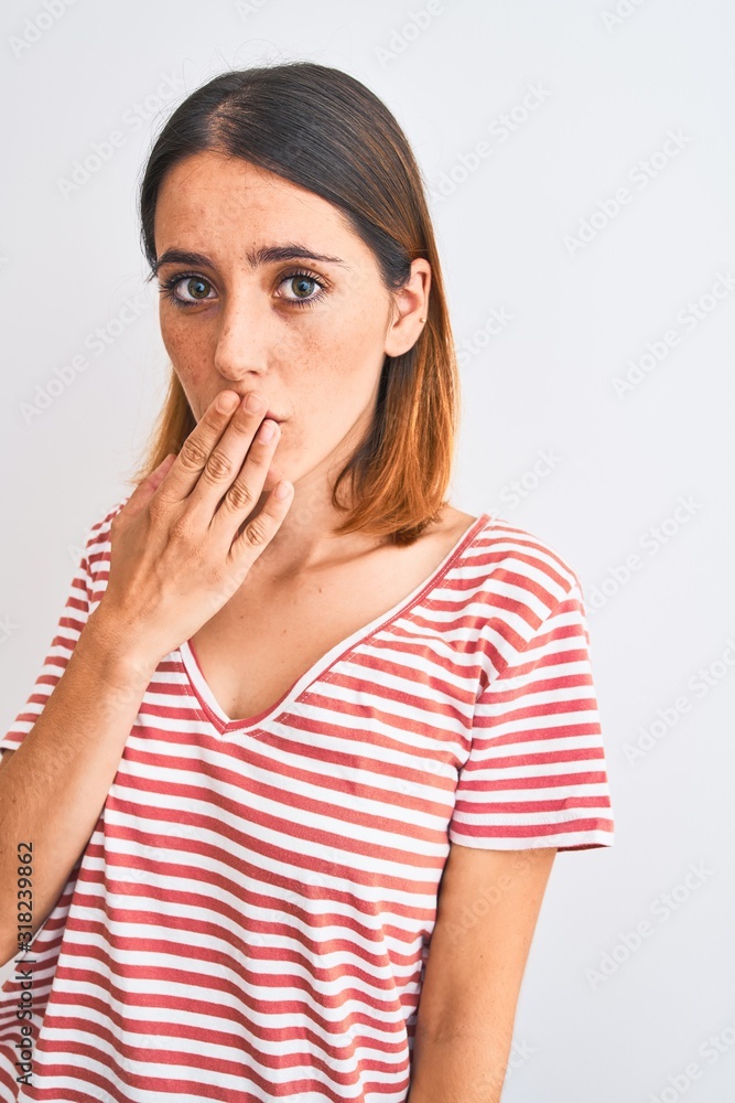 Beautiful redhead woman wearing casual striped red t-shirt over isolated background cover mouth with hand shocked with shame for mistake, expression of fear, scared in silence, secret concept Beautiful redhead woman wearing casual striped red t-shirt over isolated background cover mouth with hand shocked with shame for mistake, expression of fear, scared in silence, secret concept