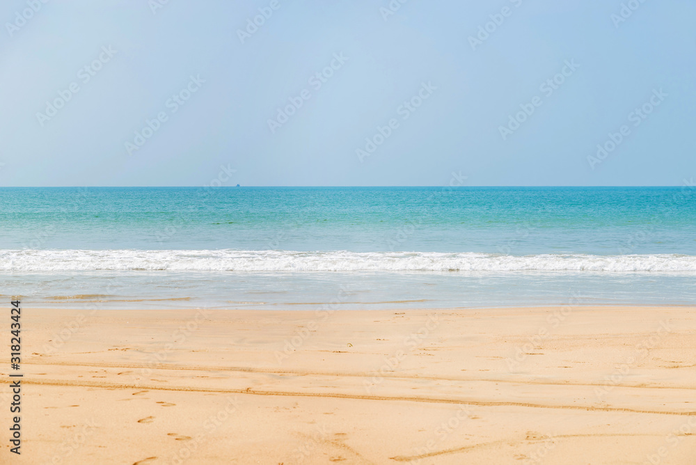 Beautiful beach view with fishing boat, yellow sand and blue ocean, Goa state in India