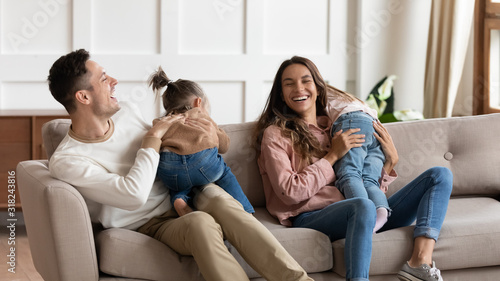 Happy young family with kids play in living room