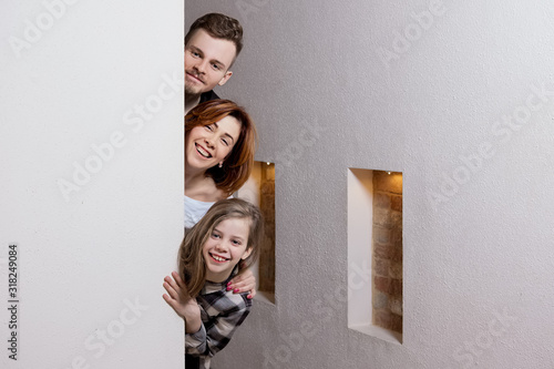 Tricky family peeks around the corner photo
