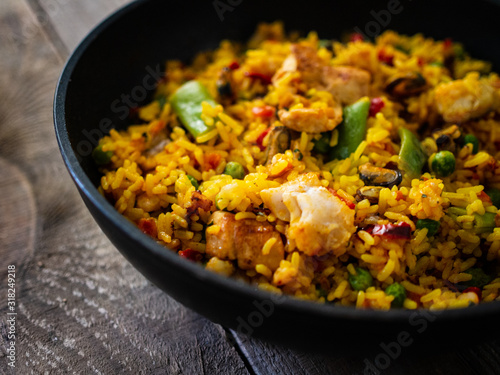 Paella seafood in cooking pan on wooden background