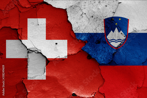 flags of Switzerland and Slovenia painted on cracked wall