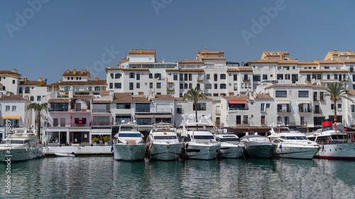 marbella marina cityscape on a sunny day with houses, boats and the sea, spain