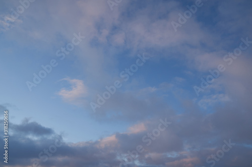 Fototapeta Naklejka Na Ścianę i Meble -  Beautiful evening blue sky at sunset with flaming bright light clouds