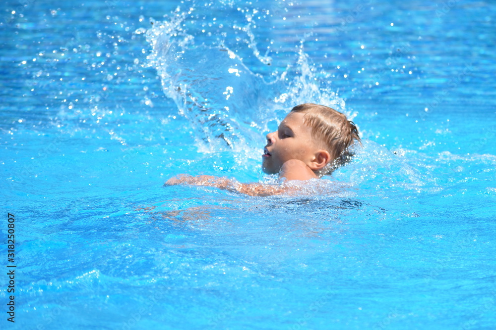 Little boy and watersports. Active holiday in the pool. swim practice