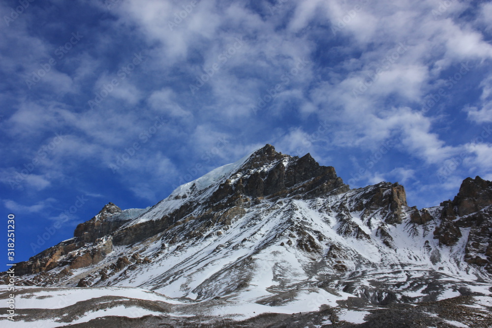 Snowy mountains against the blue sky with white clouds. Mountains of Nepal