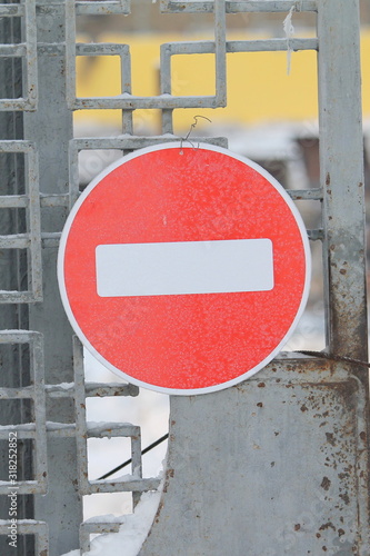 Road sign do not enter on fence.