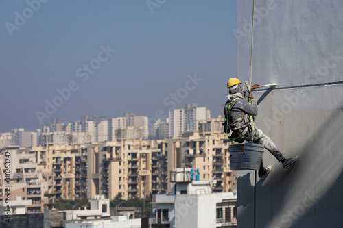 Construction workers painting a building in Noida, Uttar Prades, India © Manpreet