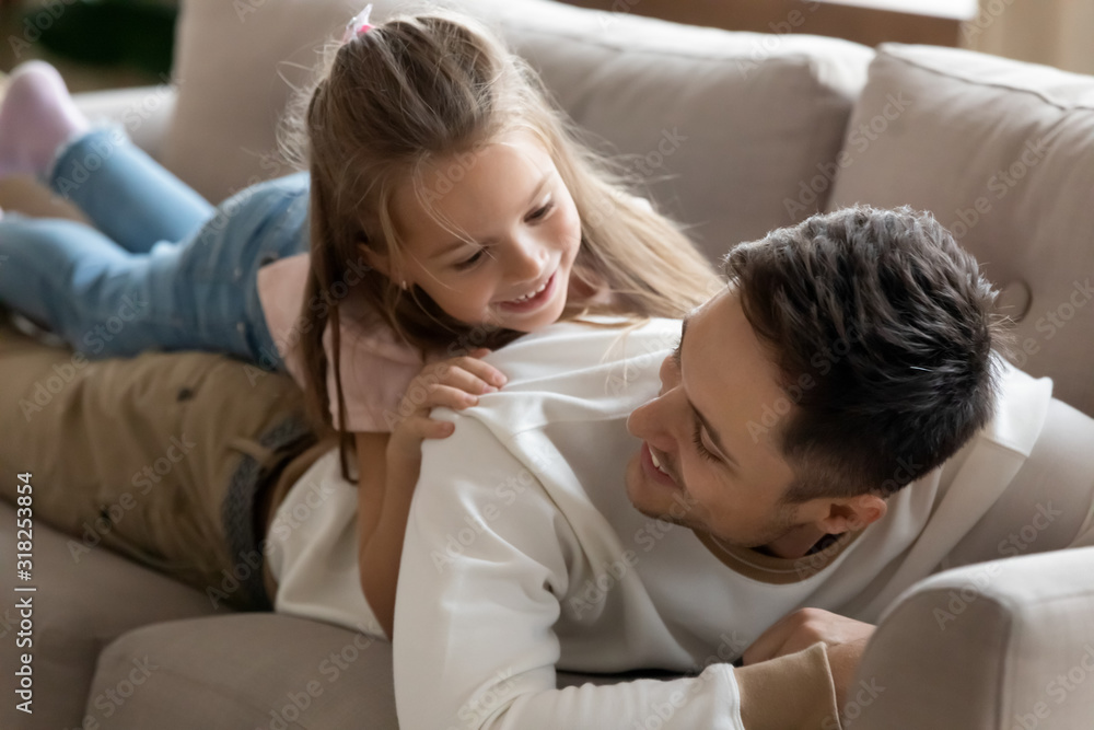Happy father relax play with little daughter on couch Happy father relax play with little daughter on couch