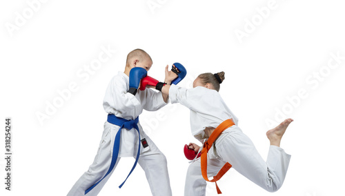 Paired exercises karate kids are training with overlays on his hands