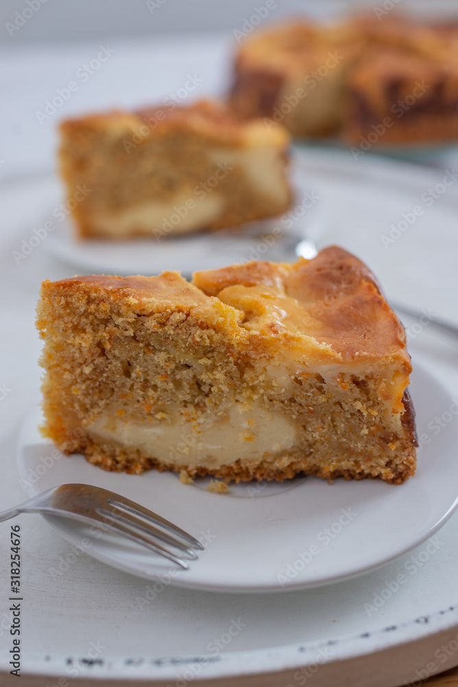 home made carrot cake cheesecake on a table home made carrot cake cheesecake on a table