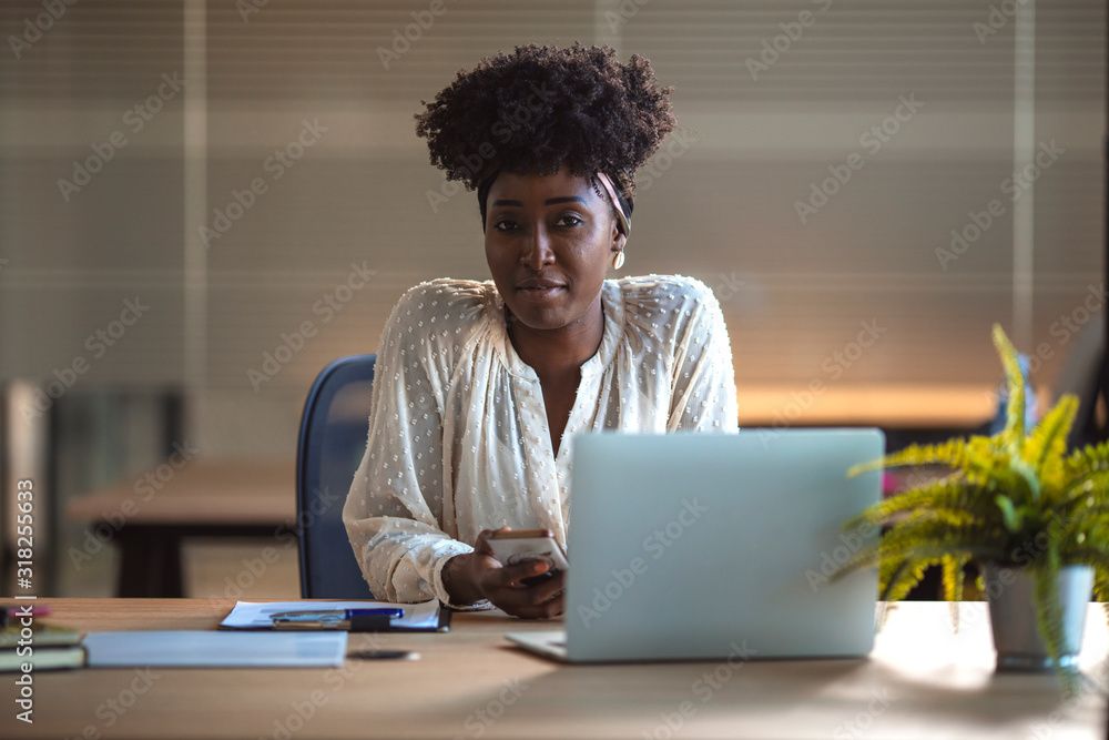 Shot of a young businesswoman using a laptop at work. Portrait of young black woman in creative office. Young African American female architect working in an office. Shot of a young businesswoman using a laptop at work. Portrait of young black woman in creative office. Young African American female architect working in an office.