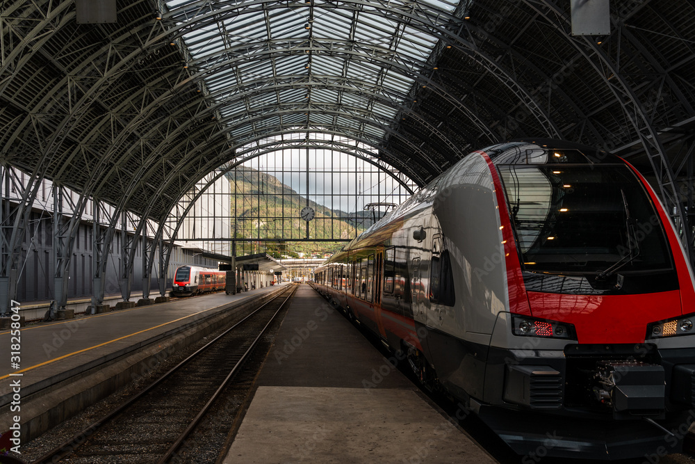 Train waiting at the railway station with the mountain landscape view on the background Train waiting at the railway station with the mountain landscape view on the background