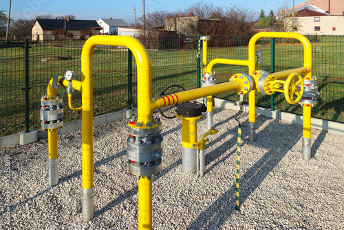 Element gas line high and medium pressure. Yellow transport pipes on the surface of the fence. Regulatory supply system for natural compressed fuel. Access overlap valves and pressure sensors photo