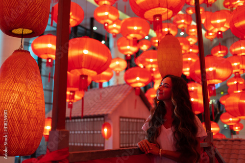 Photography Happy tourist woman enjoying traditional red lanterns decorated for Chinese new year Chunjie