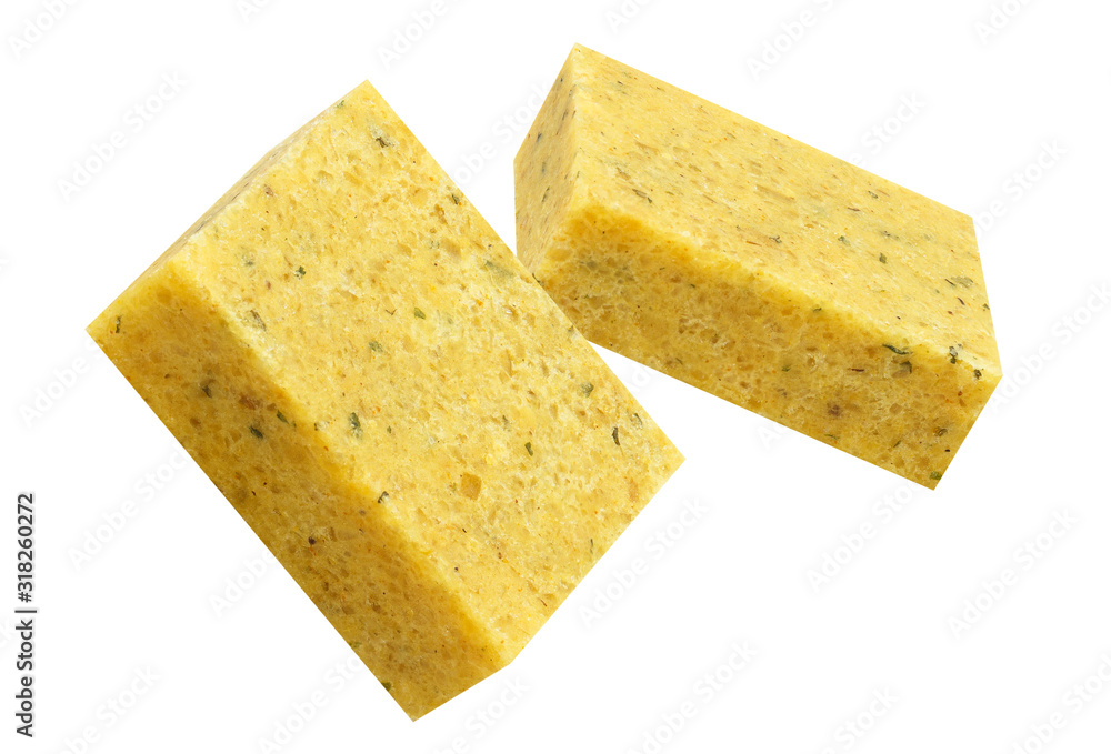 Close-up of two bouillon cubes in the air, isolated on white background